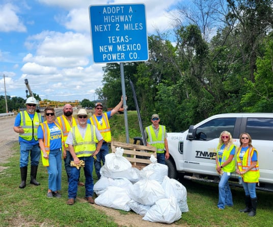 TNMP employees cleaning up trash on a highway