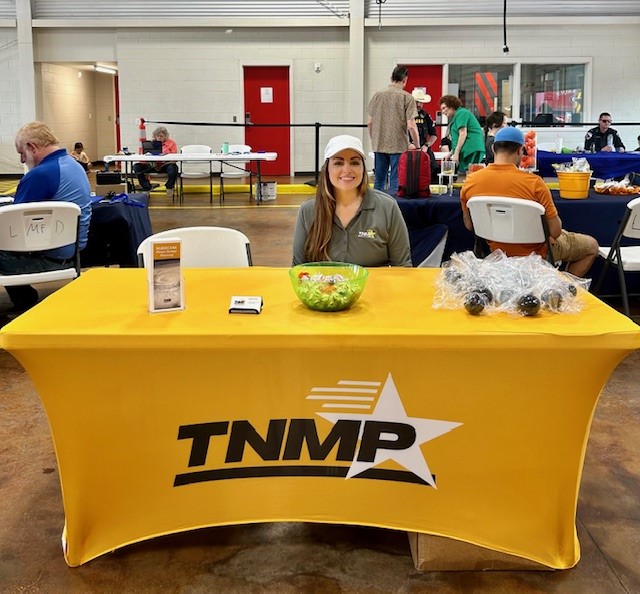 A person sitting at a table with a yellow tablecloth

Description automatically generated